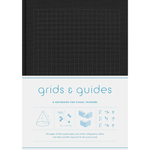 Notebook with grid pattern on cover and text 'grids & guides' on white background
