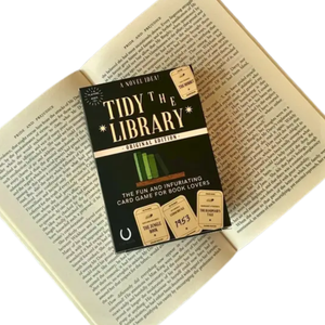 Card game box titled 'Tidy the Library' on an open book