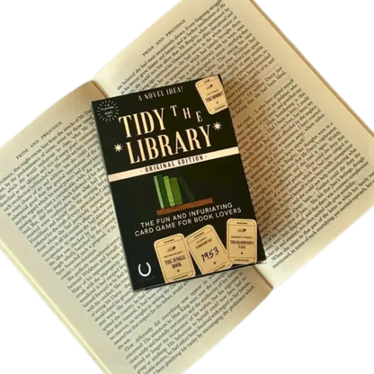 Card game box titled 'Tidy the Library' on an open book