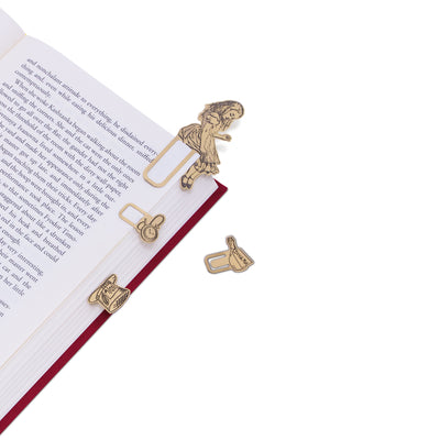 image of Alice in Wonderland Brass Bookminders clipped on the side of an open red book